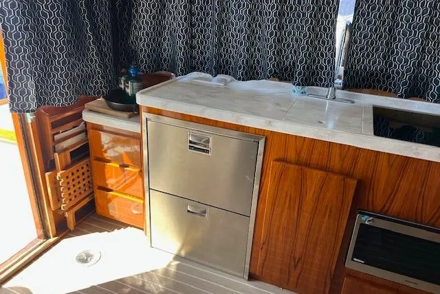 Slide: The Image of 1985 Egg Harbor 33 Convertible yacht interior with wood cabinetry and stainless steel appliances. - 20