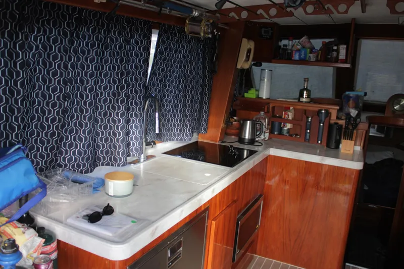 Slide: The Image of Interior of 1985 Egg Harbor 33 Convertible yacht kitchen with wooden cabinetry and modern appliances. - 22
