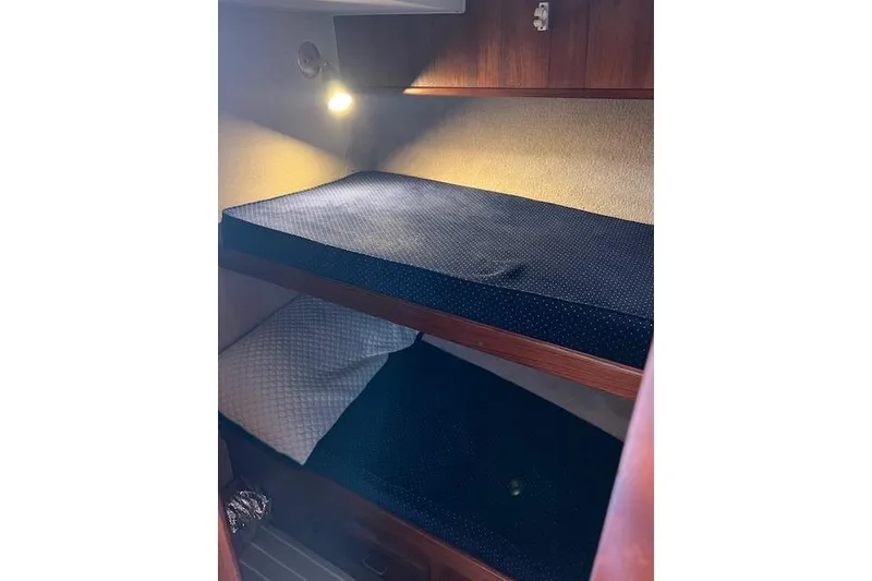 Slide: The Image of Bunk beds in 1985 Egg Harbor 33 Convertible boat cabin with cozy lighting. - 24