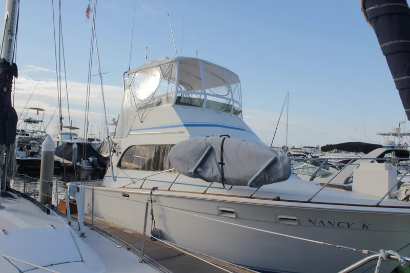 Slide: The Image of 1985 Egg Harbor 33 Convertible yacht docked at marina under clear sky. - 3
