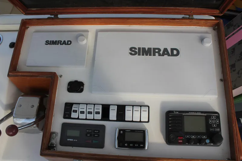 Slide: The Image of Control panel of a 1985 Egg Harbor 33 Convertible boat with Simrad equipment. - 32