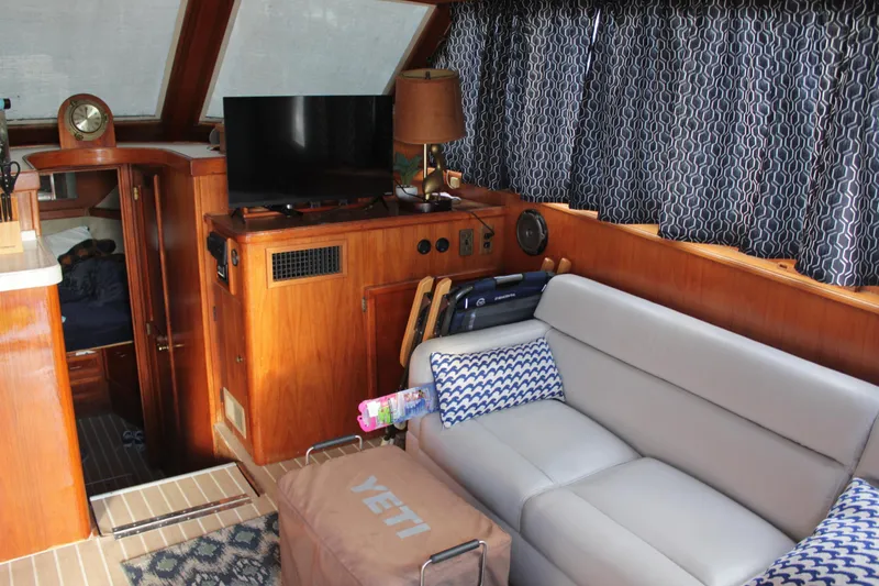 Slide: The Image of Interior of 1985 Egg Harbor 33 Convertible yacht with cozy seating and modern amenities. - 35