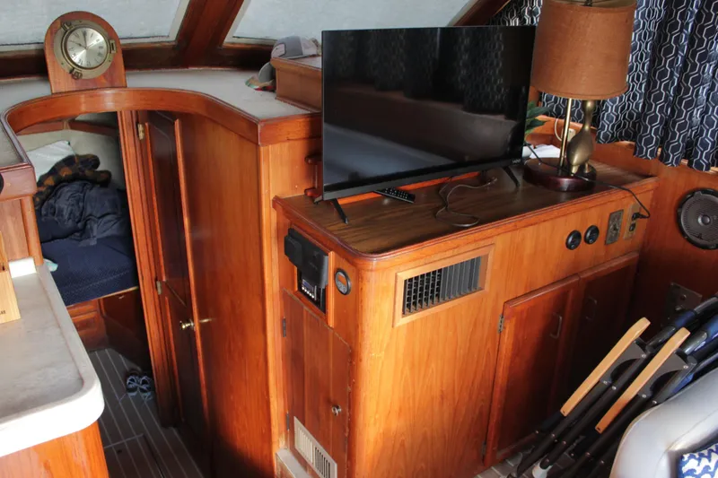 Slide: The Image of Interior of a 1985 Egg Harbor 33 Convertible boat with wood paneling and modern amenities. - 38