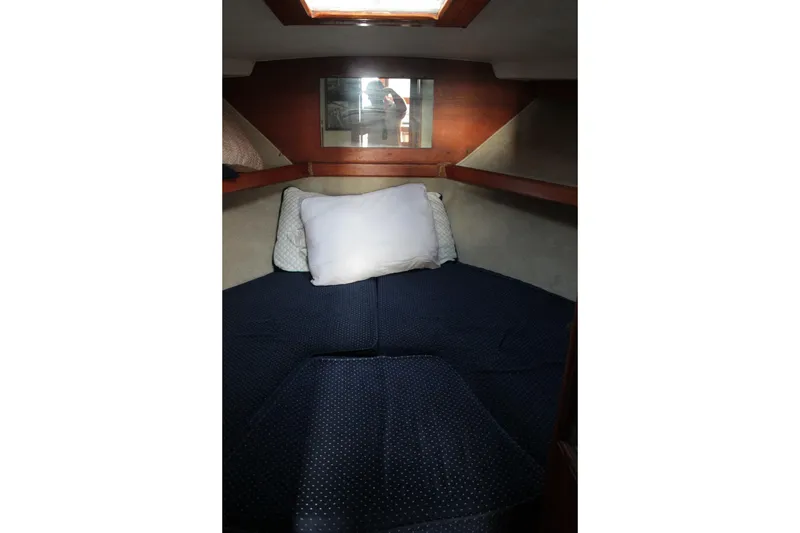Slide: The Image of Cozy cabin interior of 1985 Egg Harbor 33 Convertible boat with pillows and bedding. - 39