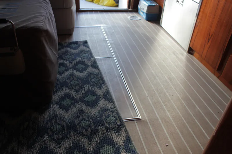 Slide: The Image of Interior of 1985 Egg Harbor 33 Convertible with patterned rug and wooden flooring. - 41