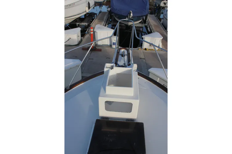 Slide: The Image of 1985 Egg Harbor 33 Convertible boat docked, showcasing bow and deck details. - 43