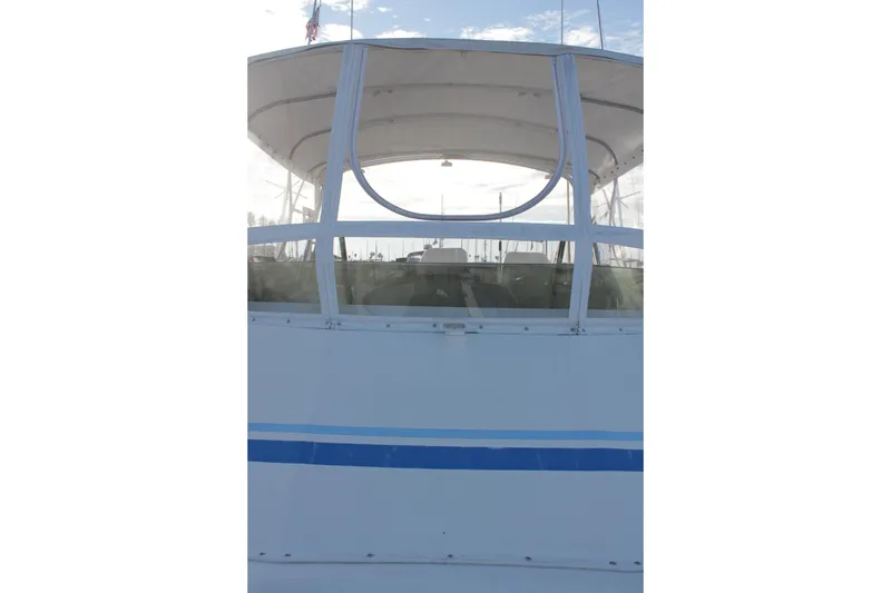Slide: The Image of 1985 Egg Harbor 33 Convertible boat with white and blue exterior, viewed from the front. - 44