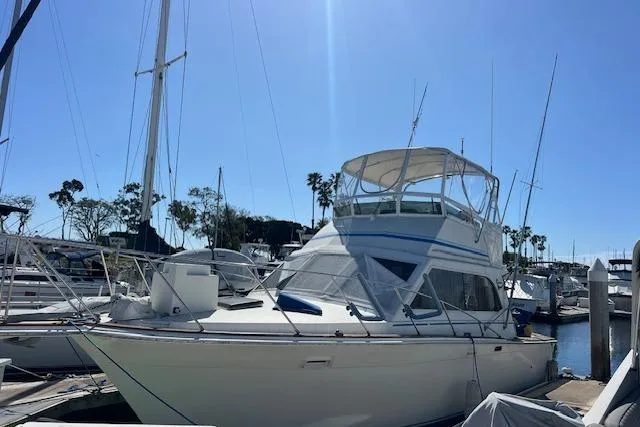 Slide: The Image of 1985 Egg Harbor 33 Convertible yacht docked in a sunny marina. - 9