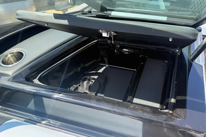 Slide: The Image of Open storage compartment in 2022 MasterCraft XT24 boat, showcasing interior space. - 19