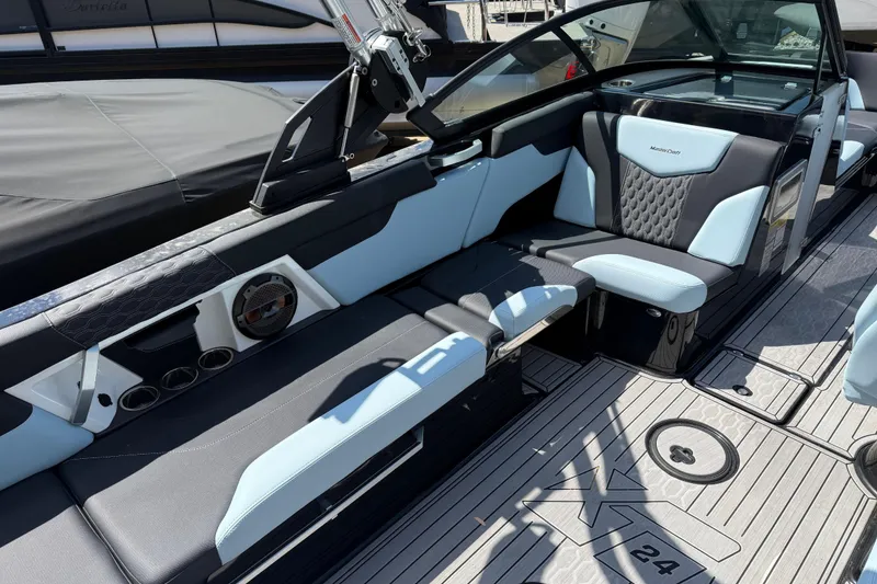 Slide: The Image of 2022 MasterCraft XT24 boat interior with sleek seating and modern design. - 20