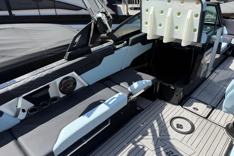Slide: The Image of 2022 MasterCraft XT24 boat interior with seating and speaker system. - 21