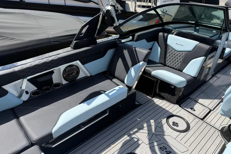 Slide: The Image of 2022 MasterCraft XT24 boat interior with stylish seating and modern design. - 22