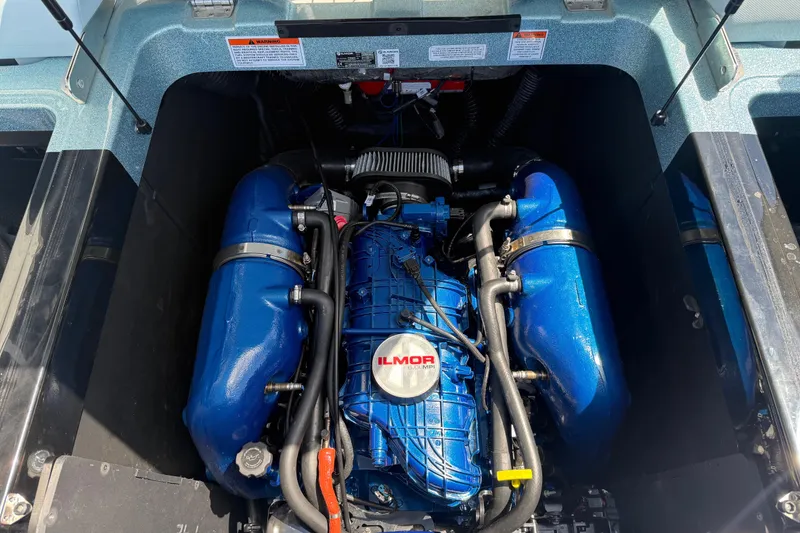 Slide: The Image of 2022 MasterCraft XT24 engine compartment with Ilmor engine, showcasing blue components. - 27