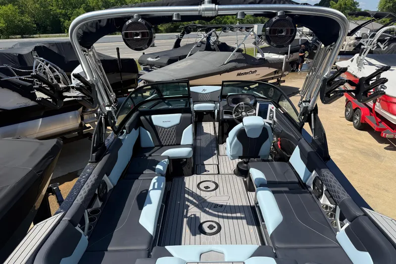 Slide: The Image of 2022 MasterCraft XT24 boat interior with sleek seating and advanced controls. - 28