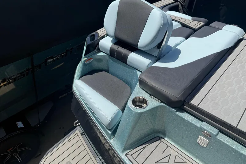 Slide: The Image of 2022 MasterCraft XT24 boat interior with stylish seating and cup holder. - 33