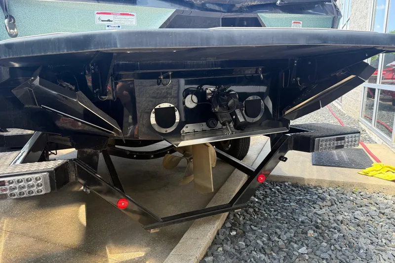 Slide: The Image of Rear view of a 2022 MasterCraft XT24 boat on a trailer, showcasing the propeller and hull design. - 35