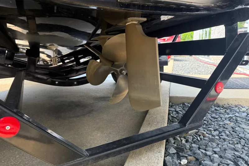 Slide: The Image of Propeller and rudder of a 2022 MasterCraft XT24 boat on a trailer. - 36
