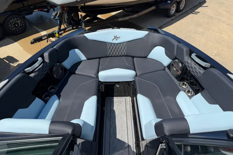 Slide: The Image of Interior of a 2022 MasterCraft XT24 boat with spacious seating and cup holders. - 5