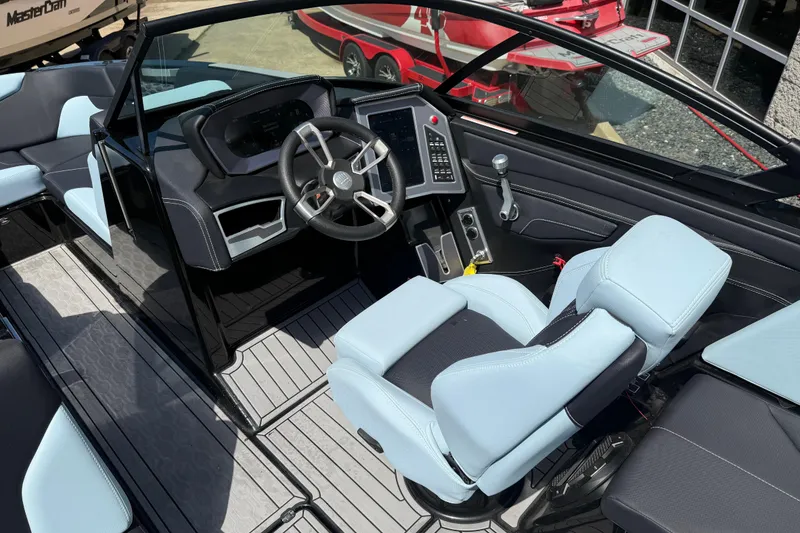 Slide: The Image of 2022 MasterCraft XT24 boat interior with modern dashboard and light blue seating. - 9