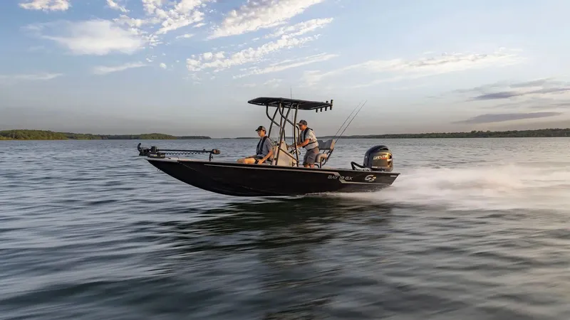 Slide: The Image of G3 Bay 19 GX boat 2026 cruising on calm water at sunset. - 12