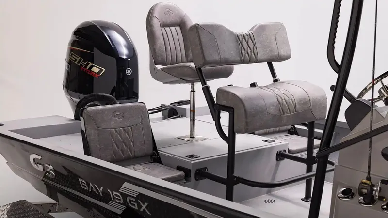 Slide: The Image of 2026 G3 Bay 19 GX boat with gray seats and outboard motor. - 8