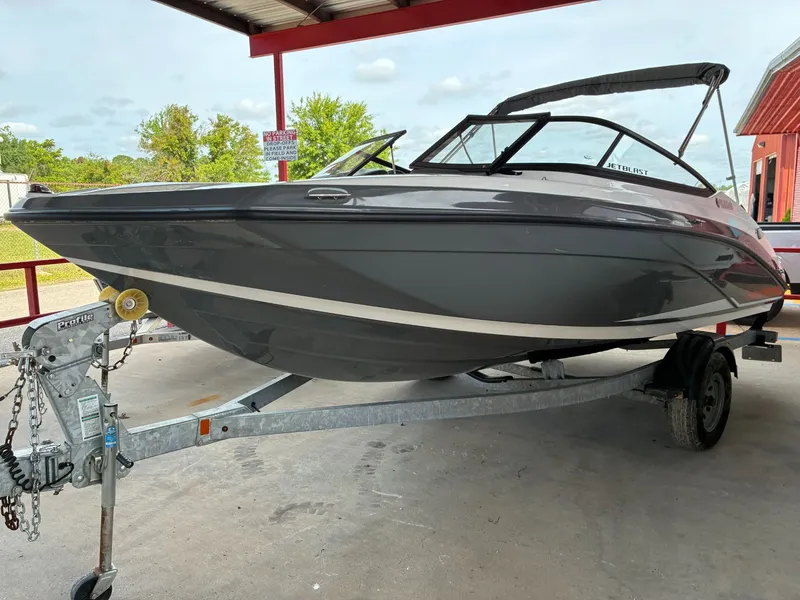 The Image of 2021 Yamaha SX190 boat on trailer under shelter. - 1