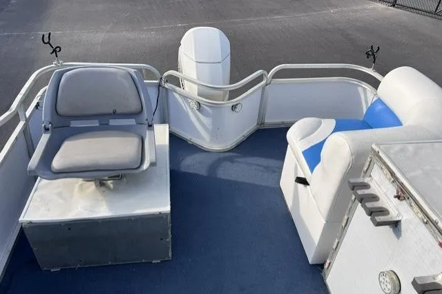 Slide: The Image of 1995 Playbuoy 20 Grand Tahoe Fisher pontoon boat interior with seating and fishing rod holders. - 11
