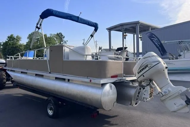 Slide: The Image of 1995 Playbuoy 20 Grand Tahoe Fisher pontoon boat with Evinrude outboard motor on trailer. - 3
