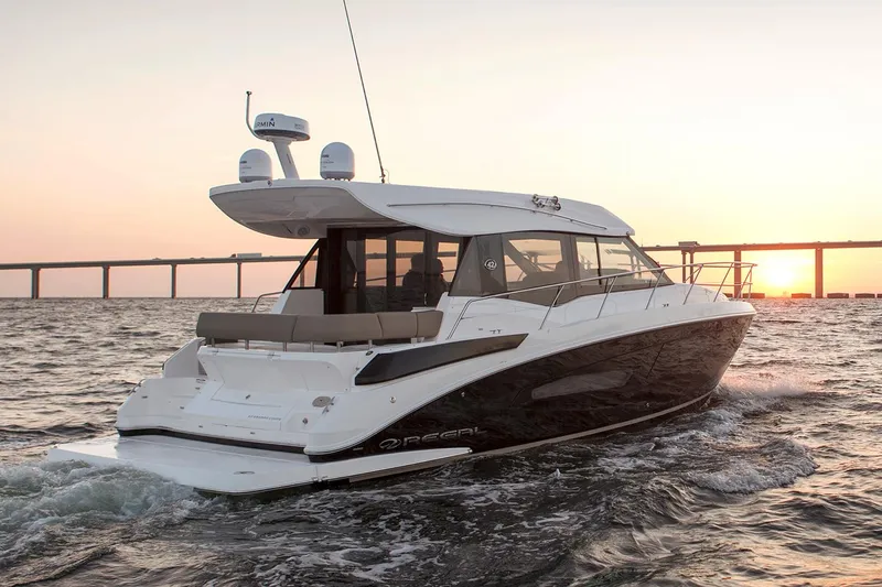 Slide: The Image of Control panel of a 2019 Regal 42 Grande Coupe yacht with switches and navigation equipment. - 16