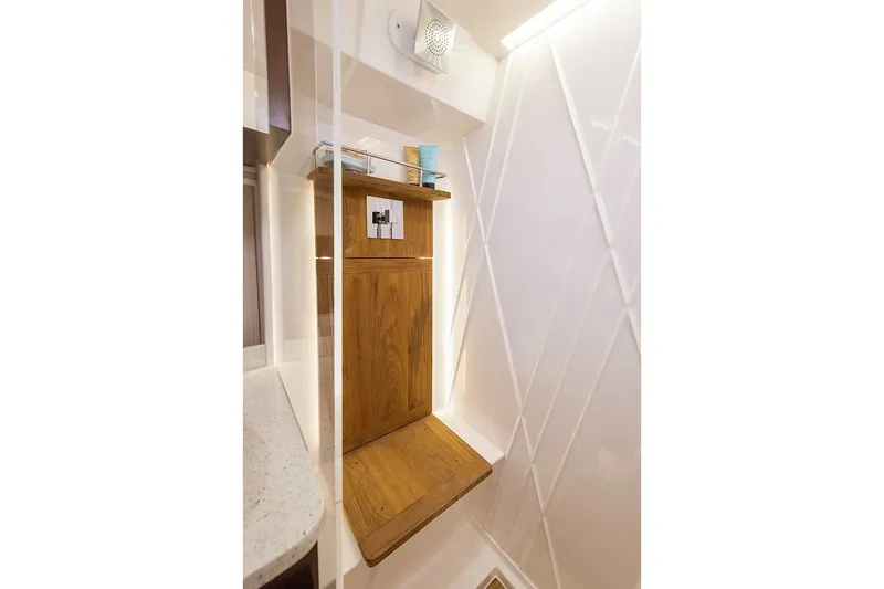 Slide: The Image of 2019 Regal 42 Grande Coupe yacht docked, showcasing sleek design and reflective windows. - 30