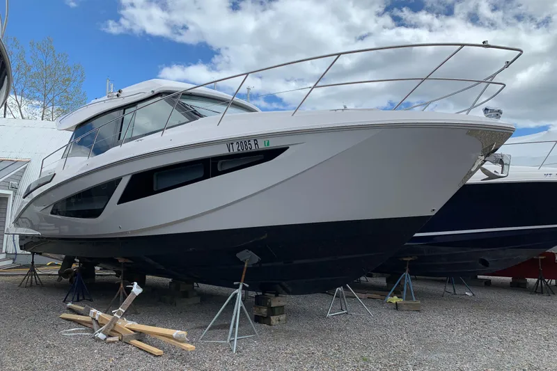Slide: The Image of 2019 Regal 42 Grande Coupe yacht on stands, under a partly cloudy sky. - 41