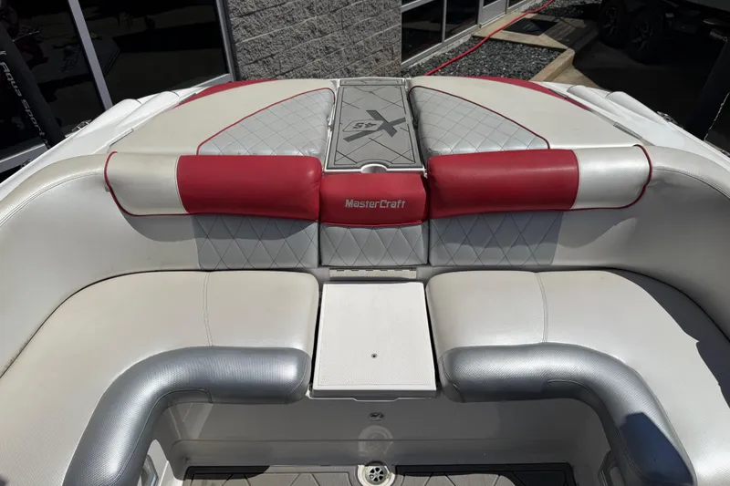 Slide: The Image of 2013 MasterCraft X-45 boat interior with red and gray seating. - 17