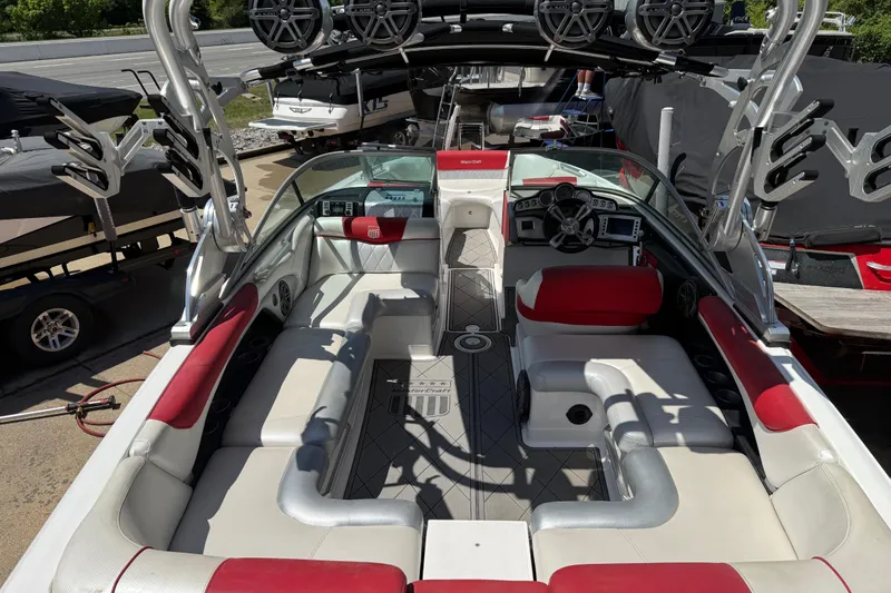 Slide: The Image of 2013 MasterCraft X-45 boat interior with red and white seating, speakers, and control panel. - 21