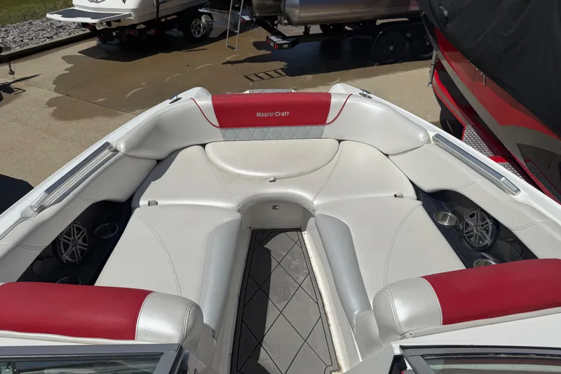 Slide: The Image of 2013 MasterCraft X-45 boat interior with white and red seating, showcasing luxury design. - 4