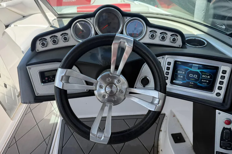 Slide: The Image of Steering wheel and dashboard of a 2013 MasterCraft X-45 boat. - 9