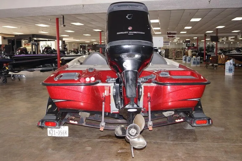 Slide: The Image of 2018 Bass Cat Pantera II boat in showroom, rear view with motor and trailer. - 2