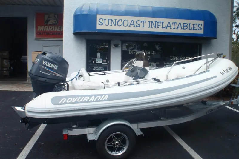 The Image of Novurania 420 DL inflatable boat, 2010 model, on trailer outside Suncoast Inflatables store. - 1
