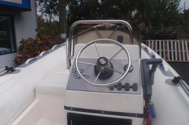Slide: The Image of 2010 Novurania 420 DL boat steering console with stainless steel wheel and control panel. - 4
