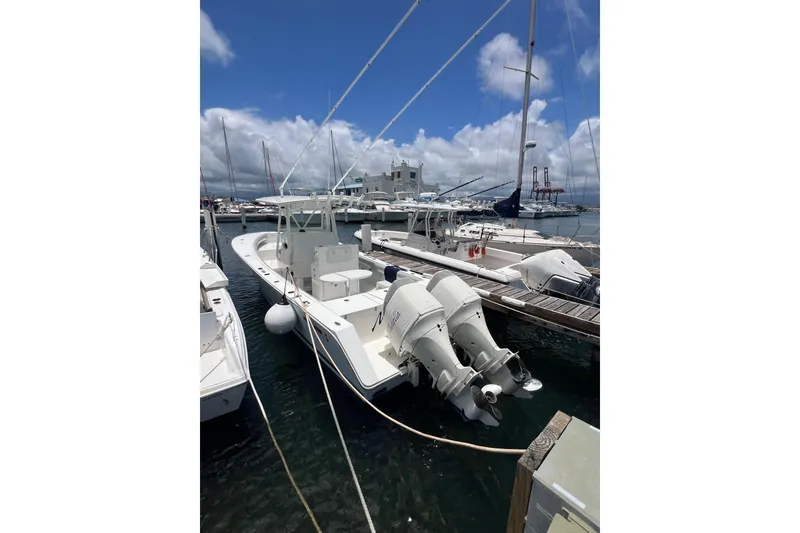 Slide: The Image of 2004 Regulator 32 Center Console boat docked with twin outboard engines. - 10