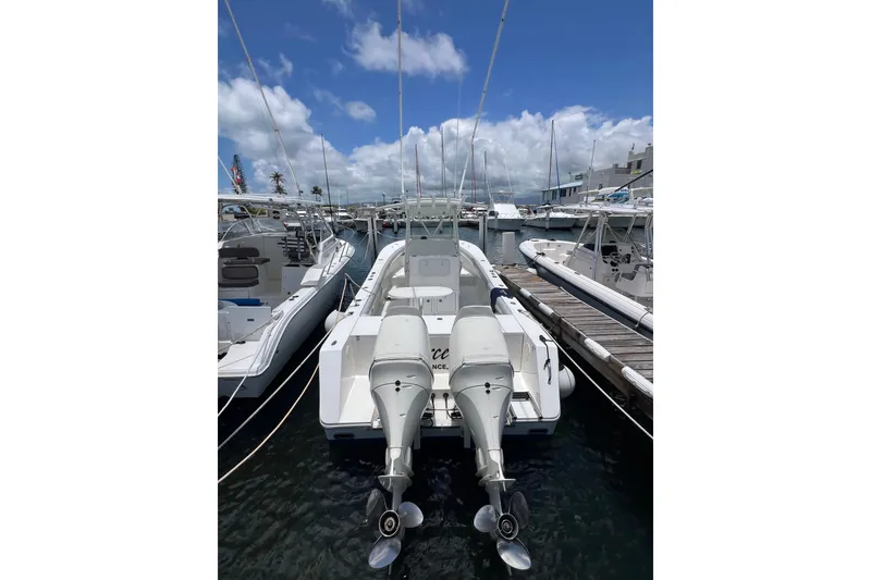 Slide: The Image of Twin Suzuki outboard engines on a 2004 Regulator 32 Center Console at a marina. - 11