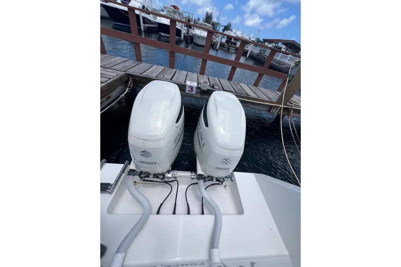 Slide: The Image of 2004 Regulator 32 Center Console boat docked under a clear blue sky. - 14