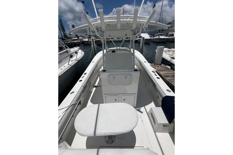 Slide: The Image of 2004 Regulator 32 Center Console boat docked, featuring a wooden table and twin engines. - 15
