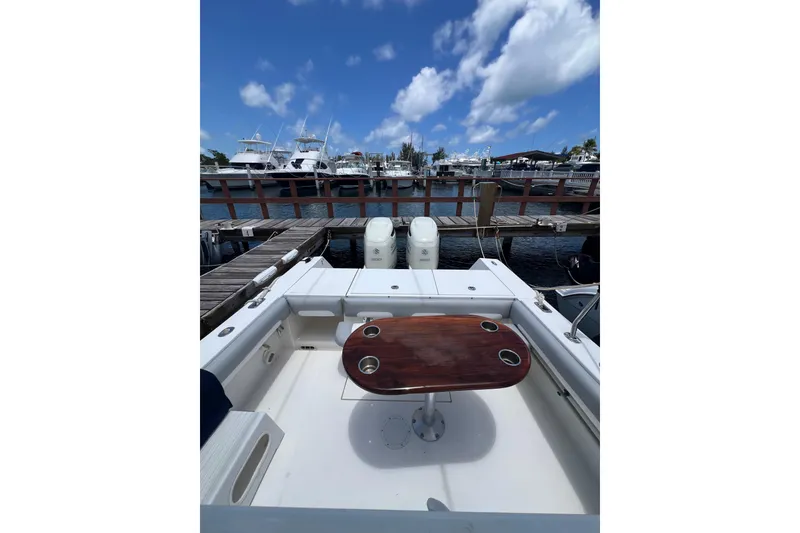 Slide: The Image of 2004 Regulator 32 Center Console boat dashboard with steering wheel and electronic controls. - 18