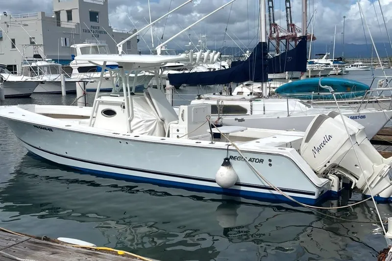 Slide: The Image of 2004 Regulator 32 Center Console boat docked at marina, top view. - 2