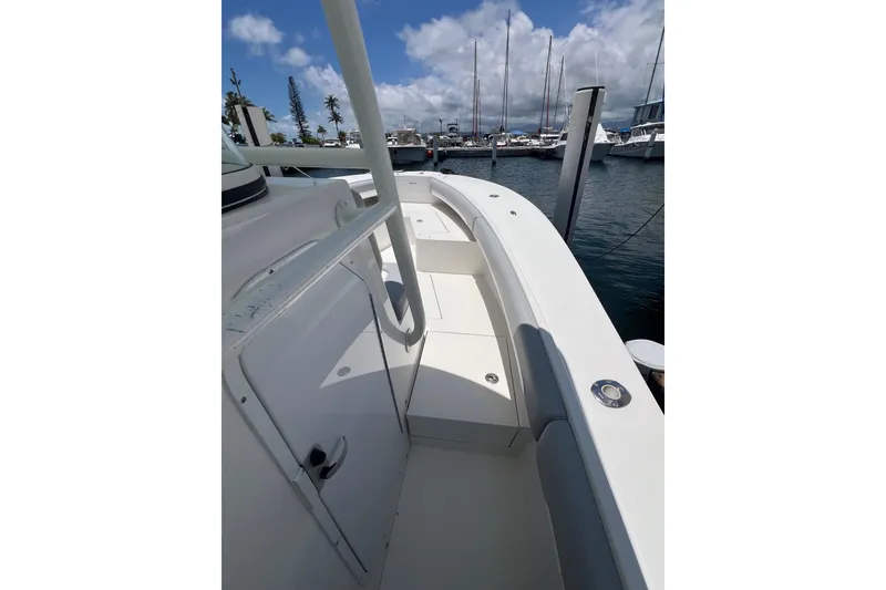 Slide: The Image of 2004 Regulator 32 Center Console boat docked at marina under blue sky. - 3