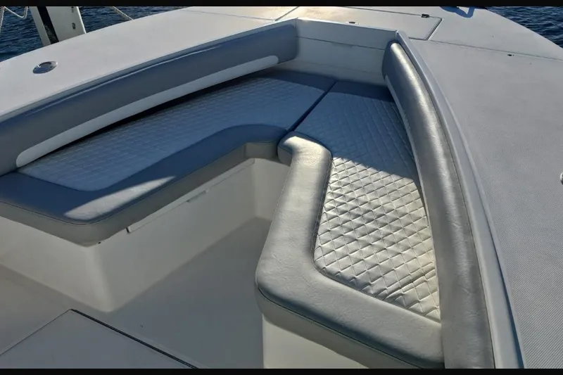 Slide: The Image of 2004 Regulator 32 Center Console boat with cushioned seating area. - 6