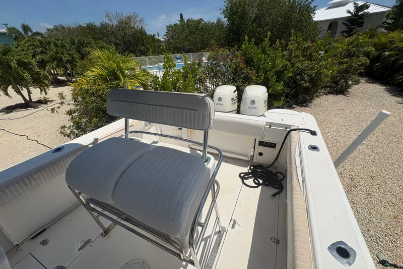 Slide: The Image of 1999 Boston Whaler 260 Outrage boat interior with seating and twin Suzuki engines. - 12