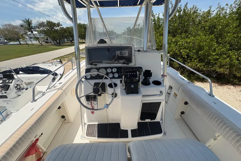 Slide: The Image of 1999 Boston Whaler 260 Outrage boat cockpit with steering wheel and control panel. - 8