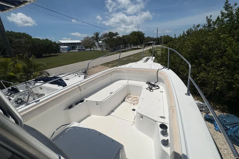Slide: The Image of 1999 Boston Whaler 260 Outrage boat deck with seating and storage, under a clear sky. - 9