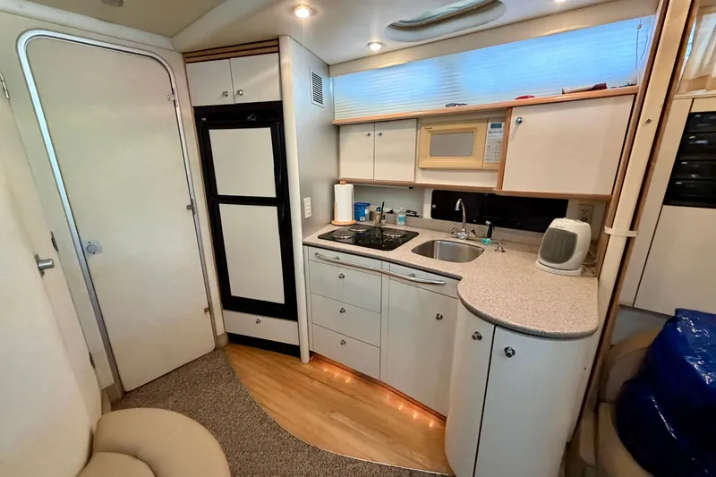 Slide: The Image of 1997 Avanti 4085 Sunbridge yacht kitchen interior with modern appliances and sleek design. - 12